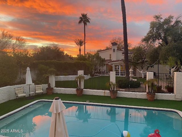 pool at dusk with a yard