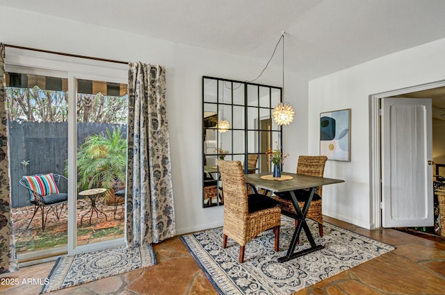 dining area featuring an inviting chandelier