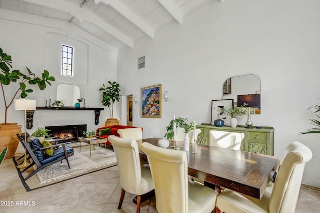 dining room featuring wood ceiling, light tile patterned floors, a brick fireplace, and vaulted ceiling with beams