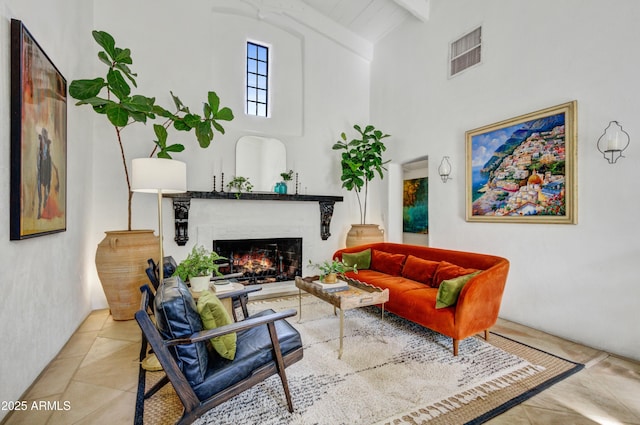 living room featuring light tile patterned flooring, beam ceiling, and high vaulted ceiling