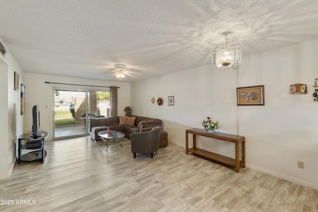 living room featuring ceiling fan with notable chandelier