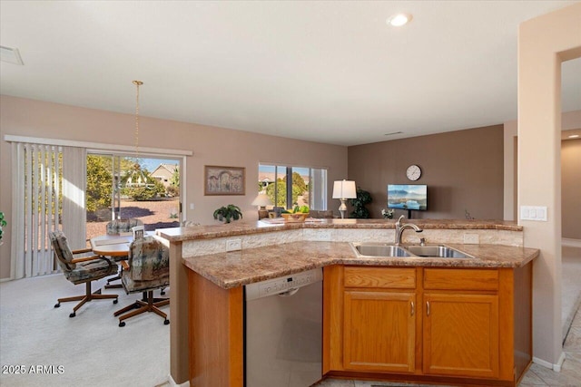 kitchen featuring sink, stainless steel dishwasher, kitchen peninsula, and light stone countertops