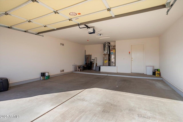 garage with a garage door opener and gas water heater