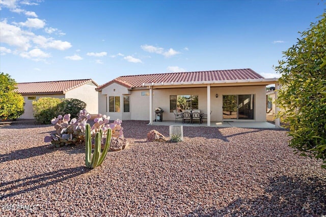 rear view of property featuring a patio