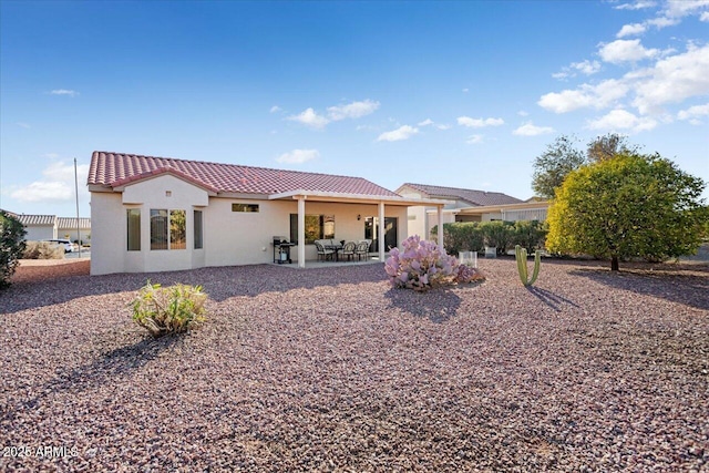 back of property featuring a patio area