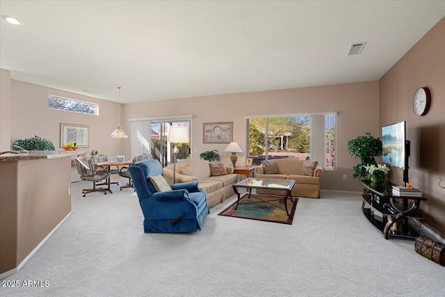 living room featuring light colored carpet and a wealth of natural light