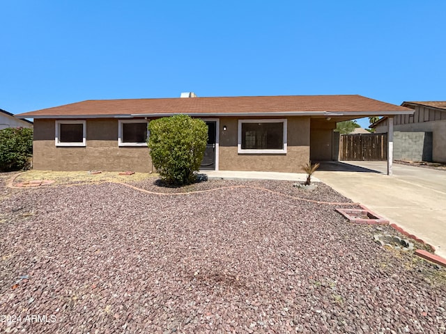 ranch-style home featuring a carport