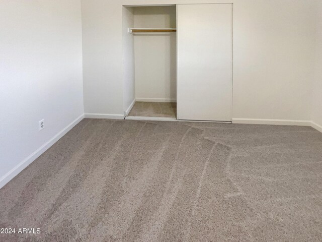 unfurnished bedroom featuring a closet and carpet