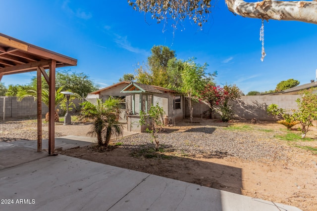 view of yard featuring a patio and an outdoor structure