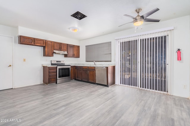 kitchen with ceiling fan, stainless steel appliances, and light wood-type flooring