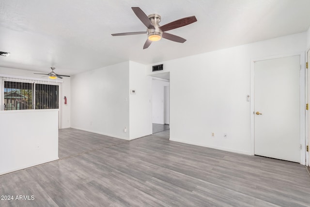 unfurnished room with ceiling fan and light wood-type flooring