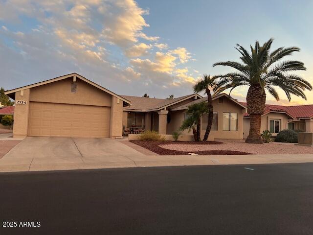 ranch-style home featuring a garage