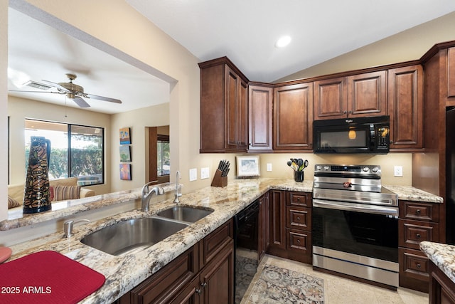 kitchen with lofted ceiling, sink, light stone counters, kitchen peninsula, and black appliances