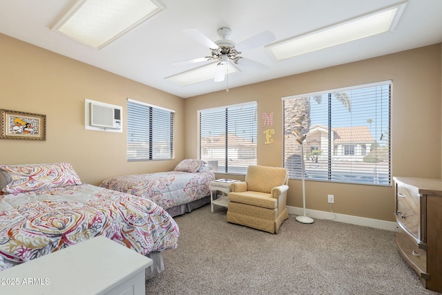 carpeted bedroom featuring ceiling fan and a wall unit AC