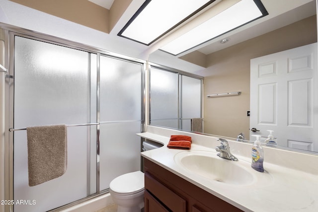 bathroom with vanity, an enclosed shower, and toilet