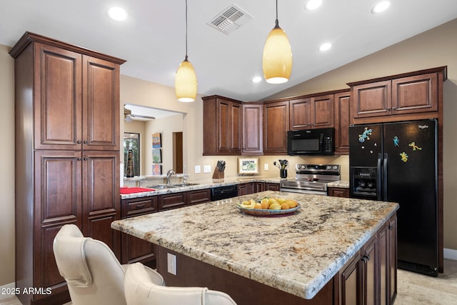 kitchen featuring pendant lighting, sink, a breakfast bar, black appliances, and light stone countertops