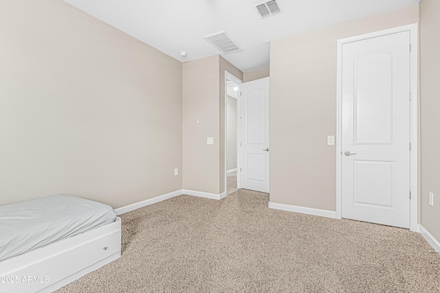 unfurnished bedroom with visible vents and baseboards
