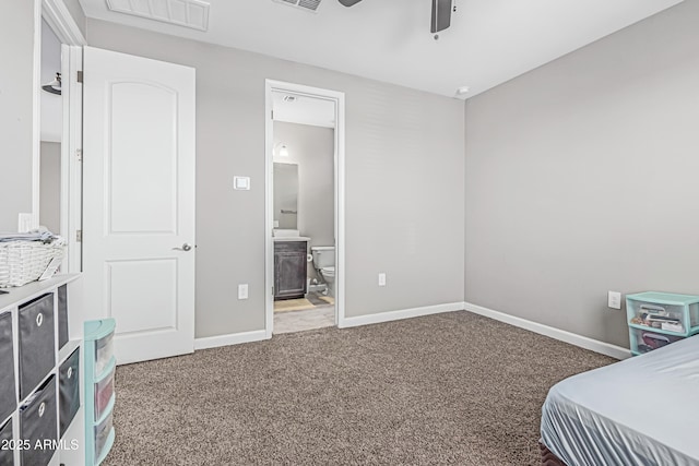 bedroom with visible vents, carpet flooring, baseboards, and ensuite bathroom