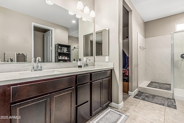 full bath featuring double vanity, a walk in shower, and a sink