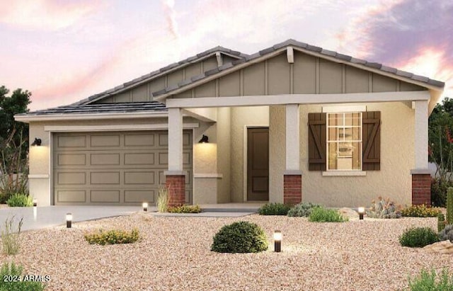 view of front facade featuring a garage and covered porch