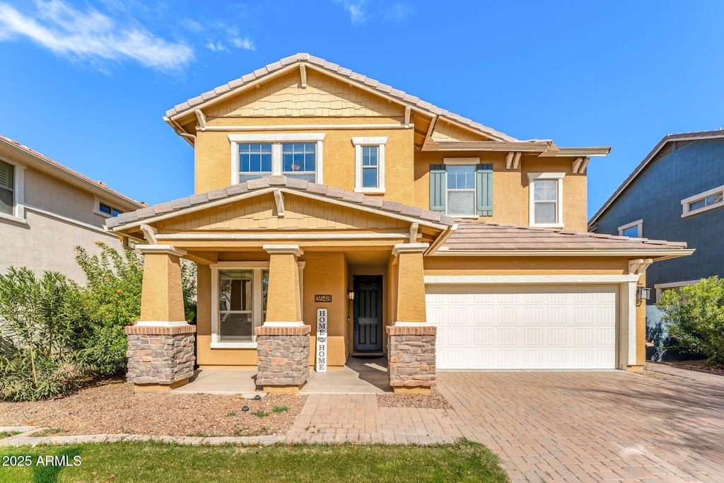 craftsman inspired home featuring a porch and a garage