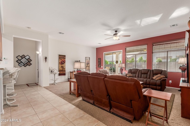 tiled living room with ceiling fan