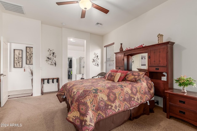 carpeted bedroom with ceiling fan and ensuite bathroom