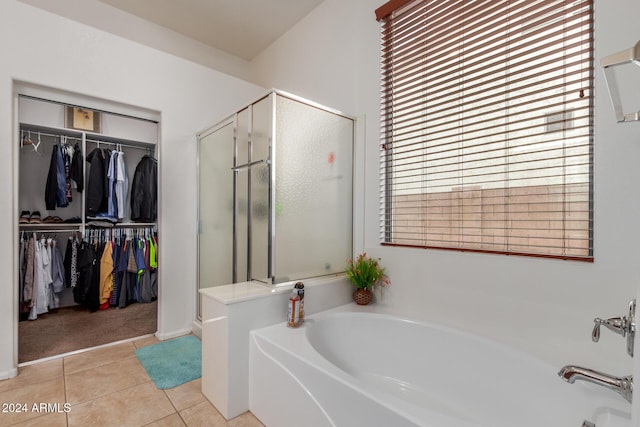 bathroom featuring plus walk in shower and tile patterned floors