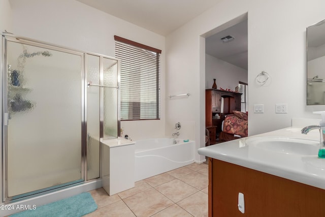 bathroom featuring tile patterned flooring, vanity, and plus walk in shower