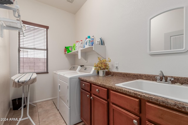 laundry room with separate washer and dryer, sink, light tile patterned floors, and cabinets