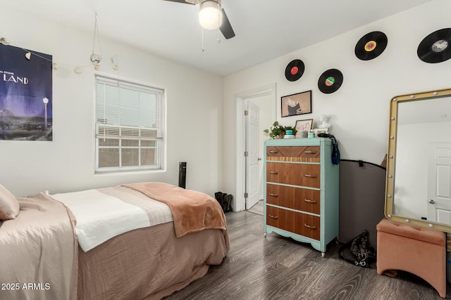 bedroom with ceiling fan and dark hardwood / wood-style floors