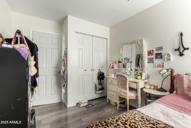 bedroom with a closet and dark hardwood / wood-style flooring