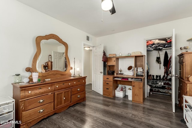 bedroom with ceiling fan, dark hardwood / wood-style floors, and a closet