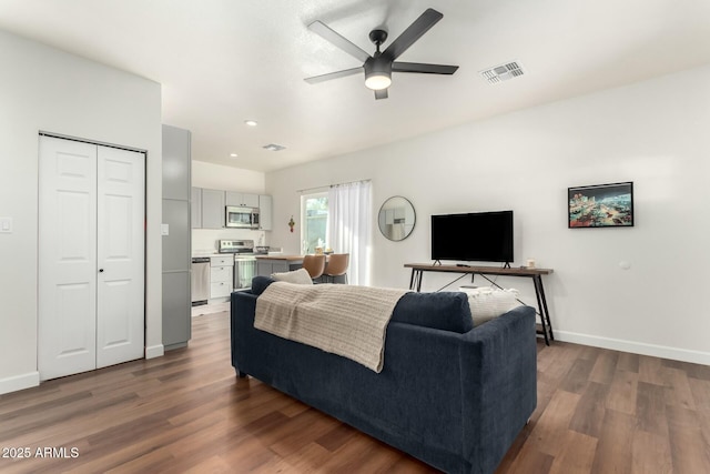 living room featuring dark hardwood / wood-style floors and ceiling fan