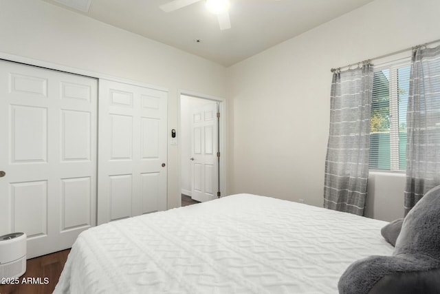 bedroom featuring a closet, ceiling fan, dark hardwood / wood-style flooring, and multiple windows