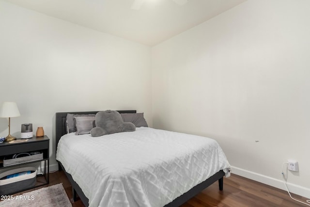 bedroom with ceiling fan and dark wood-type flooring