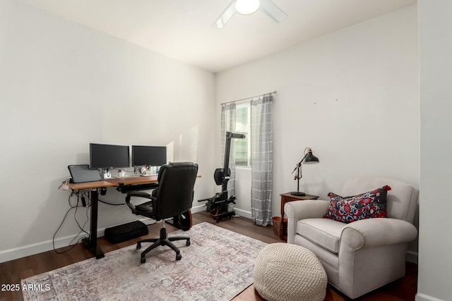 home office with ceiling fan and dark wood-type flooring