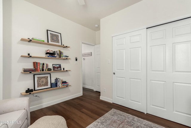 bedroom featuring dark wood-type flooring, a closet, and ceiling fan