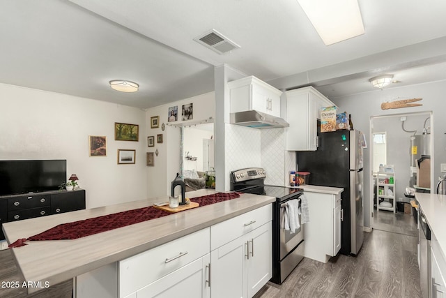 kitchen with white cabinets, appliances with stainless steel finishes, dark wood-type flooring, and water heater