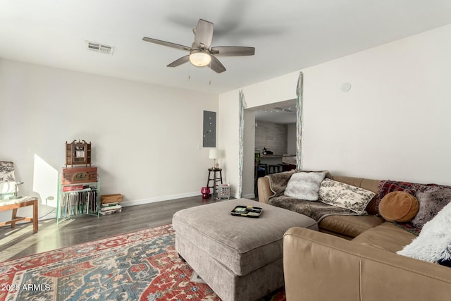 living room with ceiling fan and dark hardwood / wood-style flooring