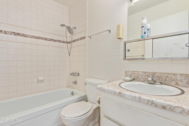 2145 W Cholla St, Phoenix, AZ 85029 - bathroom featuring vanity, toilet, tub / shower combination, tile walls, and tasteful backsplash