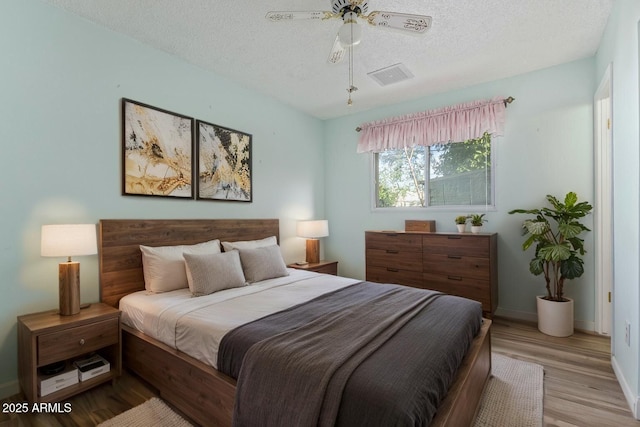 2145 W Cholla St, Phoenix, AZ 85029 - bedroom featuring baseboards, a textured ceiling, light wood-style floors, and ceiling fan