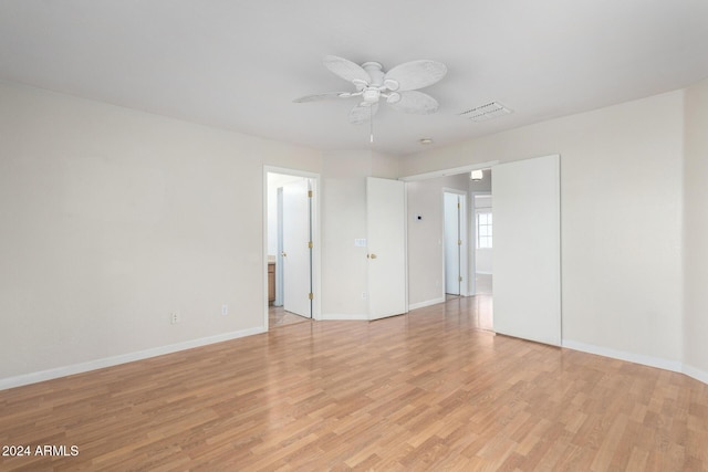 spare room featuring light wood-type flooring and ceiling fan