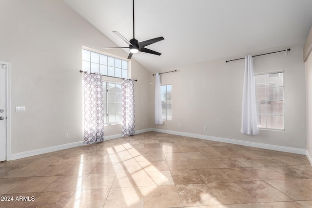 tiled empty room with high vaulted ceiling and ceiling fan