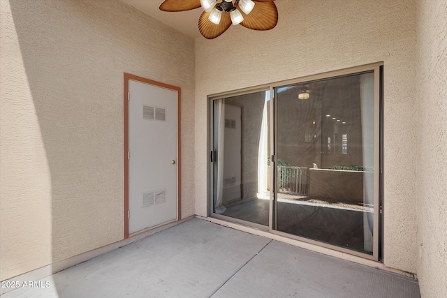 entrance to property featuring ceiling fan and a patio area