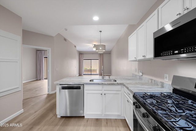 kitchen featuring sink, kitchen peninsula, white cabinets, and stainless steel appliances