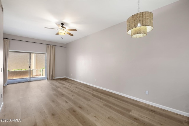 empty room with ceiling fan and hardwood / wood-style flooring