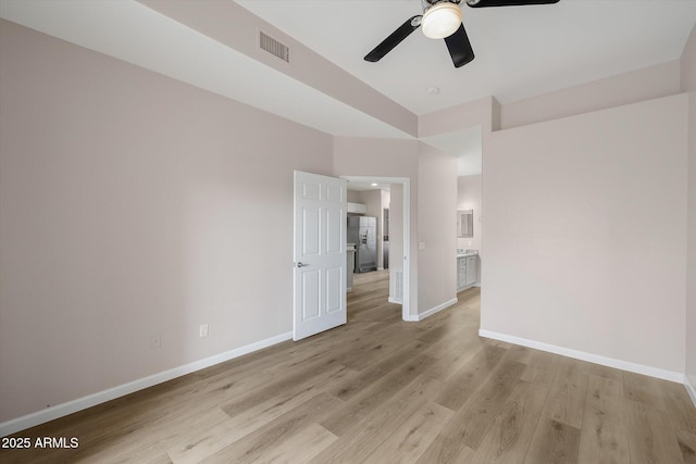 empty room featuring ceiling fan and light wood-type flooring