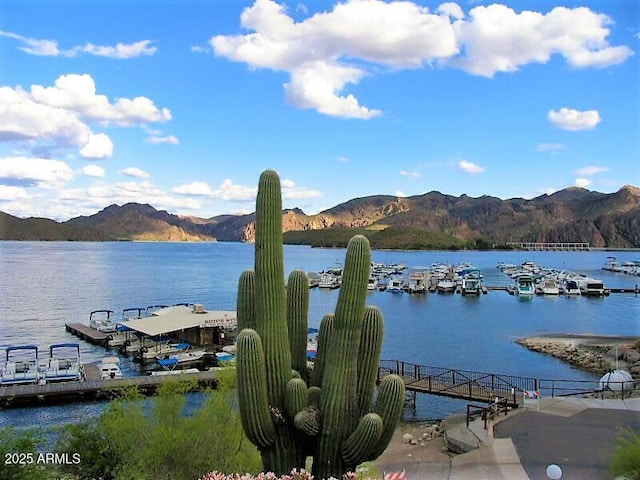 property view of water with a dock and a mountain view