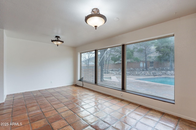 unfurnished room with a textured ceiling